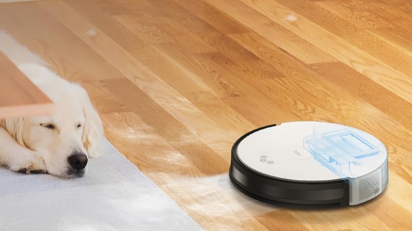 Marketing photo of the Tapo RV10 Lite robot vacuum cleaning next to a sleeping golden retriever .