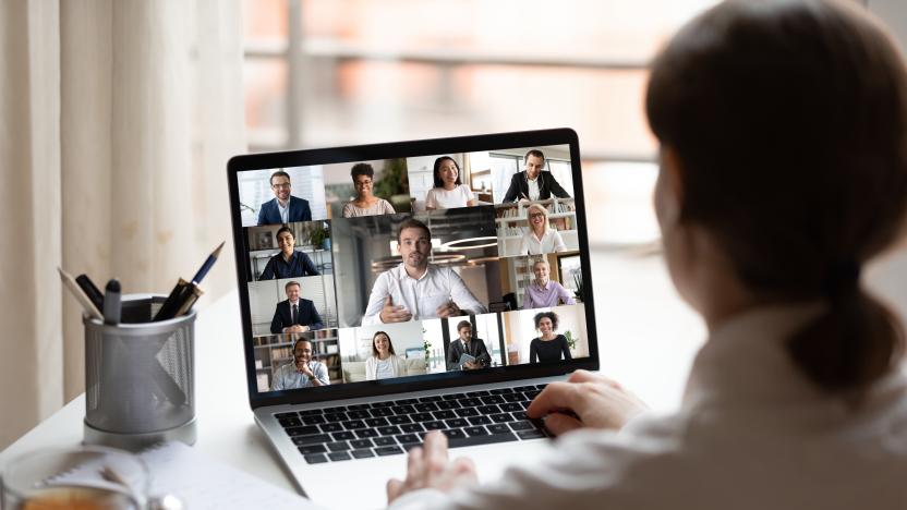 View over businesslady shoulder seated at workplace desk look at computer screen where collage of many diverse people involved at video conference negotiations activity, modern app tech usage concept