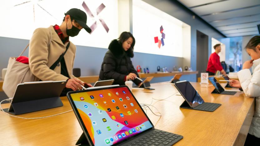 Customers admire iPad Pro products in an Apple retail store...