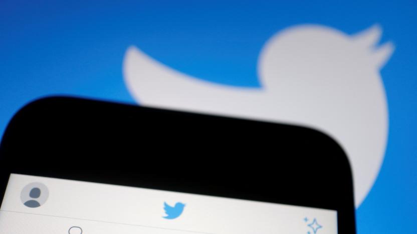 A promoted tweet on Twitter app is displayed on a mobile phone near a Twitter logo, in this illustration picture taken September 8, 2022. REUTERS/Florence Lo/Illustration