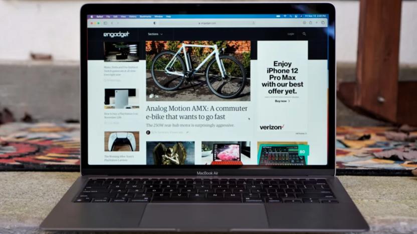 A laptop on a desk, open showing Engadget.