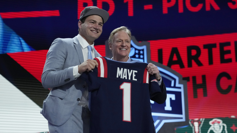 Associated Press - North Carolina quarterback Drake Maye poses with NFL commissioner Roger Goodell after being chosen by the New England Patriots with the third overall pick during the first round of the NFL football draft, Thursday, April 25, 2024, in Detroit. (AP Photo/Jeff Roberson)