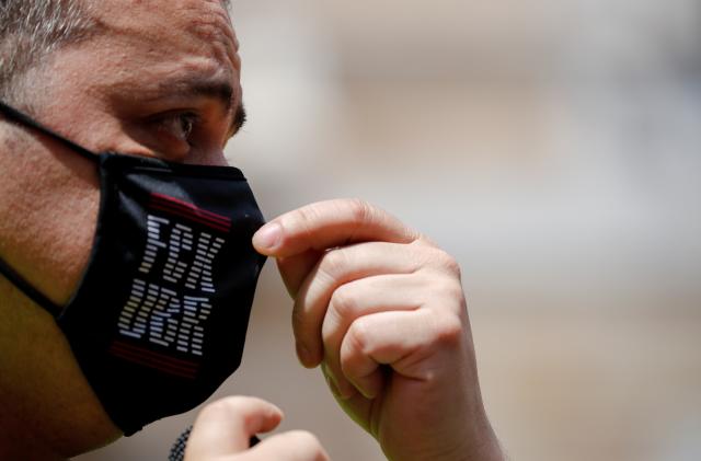 Taxi driver and union member Tito Alvarez adjusts his mask as he attends a protest against the regulation of VTC cars (Uber and Cabify) in Barcelona, Spain, May 20, 2021. REUTERS/Albert Gea