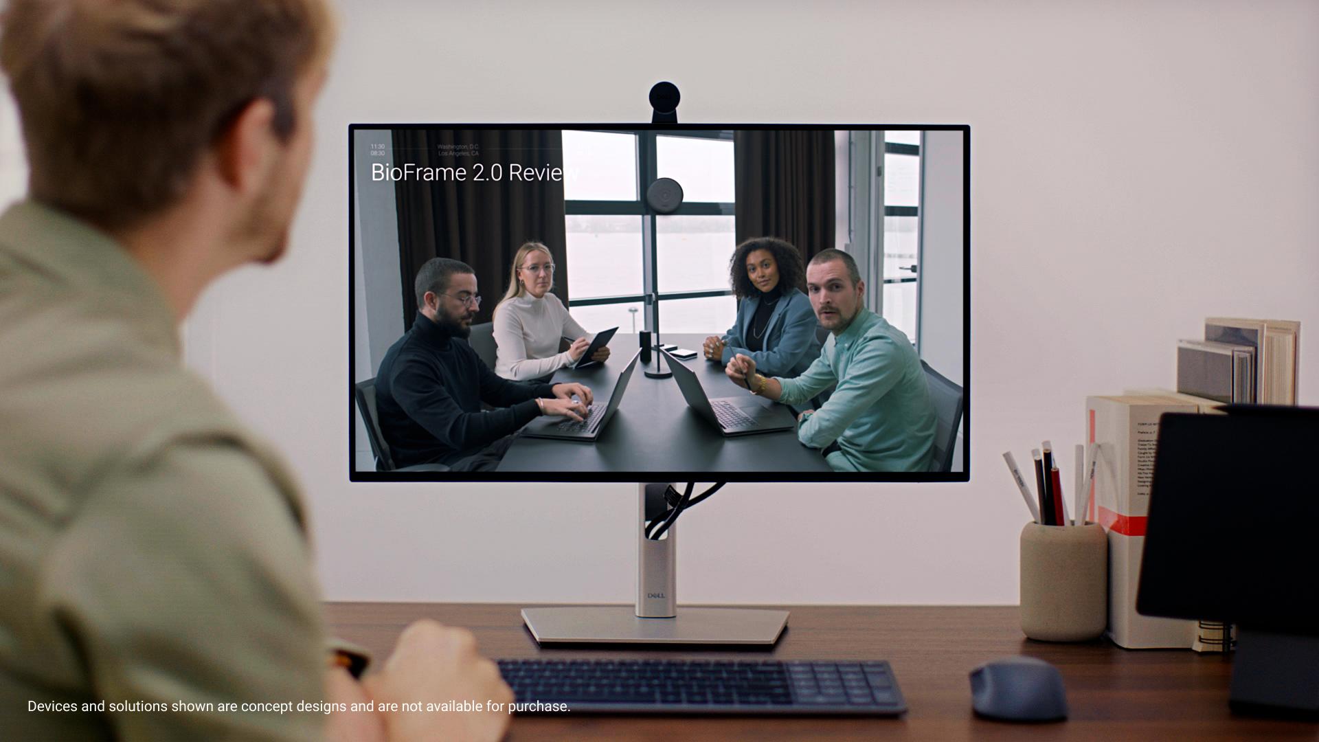 A group of people on a video call on a screen with a webcam sitting on the monitor's face. 