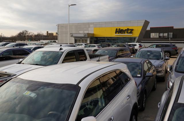 Cars are parked near Hertz car rental signage at John F. Kennedy International Airport in Queens, New York City, U.S., March 30, 2022. REUTERS/Andrew Kelly