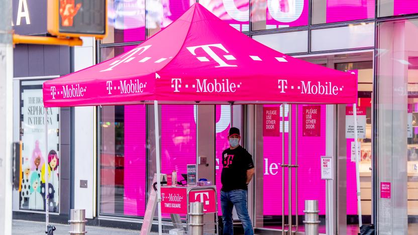 NEW YORK, NEW YORK - AUGUST 18: A clerk at the T-Mobile store in Times Square provides curb side service during the fourth phase of the coronavirus reopening on August 18, 2020 in New York, New York. The fourth phase allows outdoor arts and entertainment, sporting events without fans and media production. (Photo by Roy Rochlin/Getty Images)