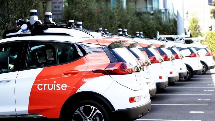 A lineup of cars with the Cruise logo painted on their sides.