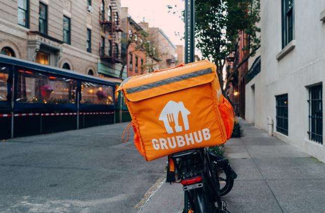 New York, USA - November 21, 2022: Grubhub bag on a delivery bike on a street in NYC. Grubhub online food order and delivery has been a subsidiary of the Dutch company Just Eat Takeaway since 2021.