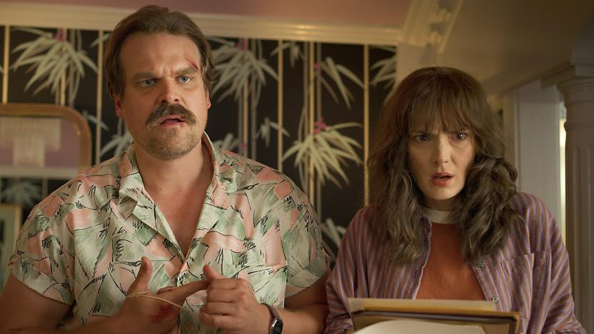 Jim Hopper (David Harbour) and Joyce Byers (Winona Ryder) in Stranger Things. Hopper has cuts on his face and both characters have their mouths open as if they're dumbfounded.