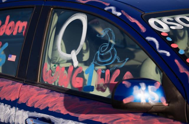 PRESCOTT, AZ - OCTOBER 19: A person's car references the Q-Anon conspiracy theory identified by the FBI as a domestic terror threat before a campaign rally for U.S. President Donald Trump on October 19, 2020 in Prescott, Arizona. With almost two weeks to go before the November election, President Trump is back on the campaign trail with multiple daily events as he continues to campaign against Democratic presidential nominee Joe Biden.  (Photo by Caitlin O'Hara/Getty Images)