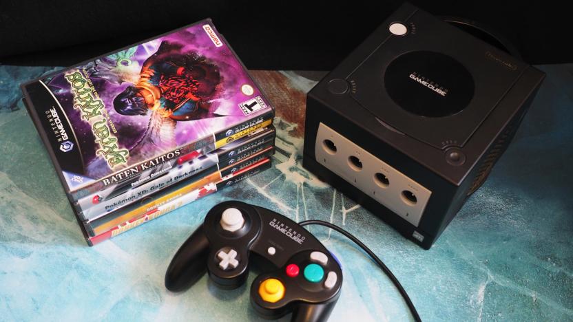 Nintendo GameCube in black, with controller and a stack of games