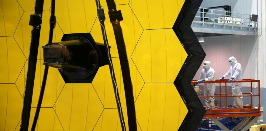 NASA workers are lifted alongside the James Webb Space Telescope Mirror during it's media reveal at NASA’s Goddard Space Flight Center at Greenbelt, Maryland, U.S., November 2, 2016.REUTERS/Kevin Lamarque