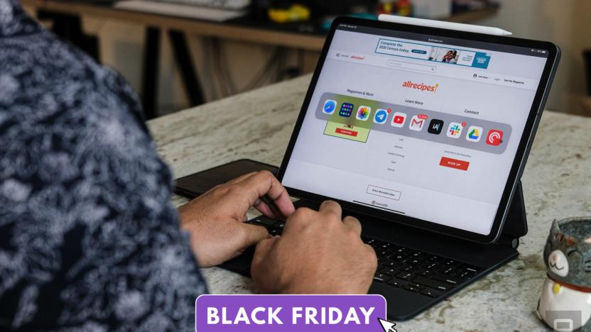 Photo of a person typing on an iPad Pro with Magic Keyboard accessory. The device sits on a marble counter. A purple tag reading "Black Friday" is overlaid at the bottom.