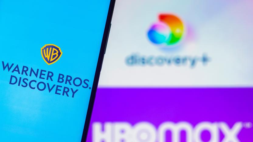 BRAZIL - 2022/08/05: In this photo illustration, the Warner Bros. Discovery logo is displayed on a smartphone screen and in the background, the HBO Max and Discovery Plus logos. (Photo Illustration by Rafael Henrique/SOPA Images/LightRocket via Getty Images)