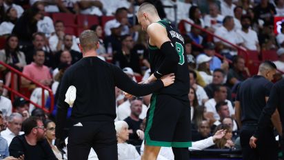 Getty Images - MIAMI, FLORIDA - APRIL 29: Kristaps Porzingis #8 of the Boston Celtics leaves the game against the Miami Heat during the second quarter after suffering an apparent injury in game four of the Eastern Conference First Round Playoffs at Kaseya Center on April 29, 2024 in Miami, Florida.  NOTE TO USER: User expressly acknowledges and agrees that, by downloading and or using this photograph, User is consenting to the terms and conditions of the Getty Images License Agreement. (Photo by Megan Briggs/Getty Images)