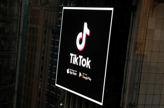 The TikTok logo is seen on a screen over Times Square in New York City, U.S., March 6, 2020. REUTERS/Andrew Kelly