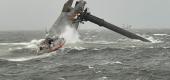 A Coast Guard Station Grand Isle 45-foot Respone Boat-Medium boatcrew heads toward a capsized 175-foot commercial lift boat Tuesday, April 13, 2021. (U.S. Coast Guard Coast Guard Cutter Glenn Harris via AP)