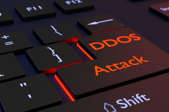 Black computer keyboard with the words DDOS attack on the enter key distributed denial of service concept 3D illustration