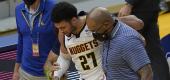 Denver Nuggets guard Jamal Murray is helped off the floor during the second half of an NBA basketball game against the Golden State Warriors. (AP Photo/Jeff Chiu)