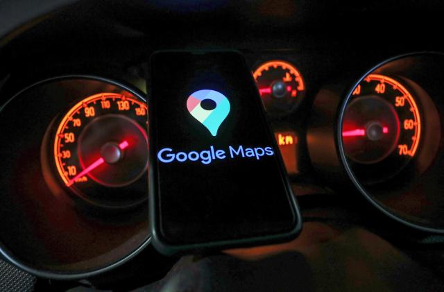 Google Maps logo displayed on a phone screen and car gauges are seen in this illustration photo taken in Krakow, Poland on January 13, 2023. 