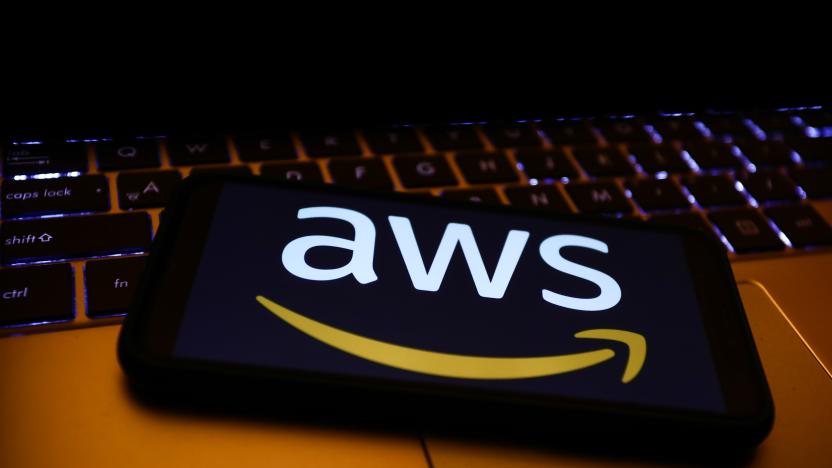 Amazon Web Services logo displayed on a phone screen and a laptop keyboard are seen in this illustration photo taken in Krakow, Poland on December 1, 2021. (Photo by Jakub Porzycki/NurPhoto via Getty Images)