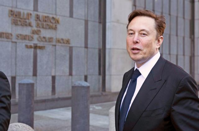 FILE - Elon Musk leaves the Phillip Burton Federal Building and United States Court House in San Francisco, Tuesday, Jan. 24, 2023. A federal appeals court Friday, July 21, said it will reconsider its March ruling that Musk unlawfully threatened employees with a loss of stock options in a 2018 Twitter post amid an organizing effort by the United Auto Workers union.