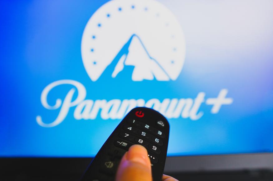 BRAZIL - 2022/05/10: In this photo illustration, a hand holding a TV remote control in front of the Paramount Plus logo on a TV screen. (Photo Illustration by Rafael Henrique/SOPA Images/LightRocket via Getty Images)