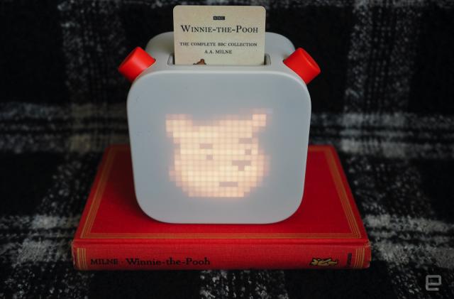 Yoto Player playing Winnie the Pooh on top of a hardcover copy of Winnie the Pooh