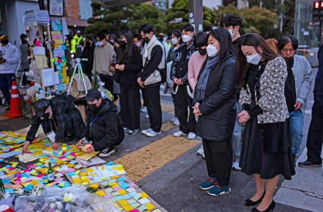 People cry during tribute for the victims of the Halloween disasters in Itaewon on November 3, 2022 in Seoul, South Korea. According to the National Fire Agency 156 have been reported killed and at least 187 others were injured.