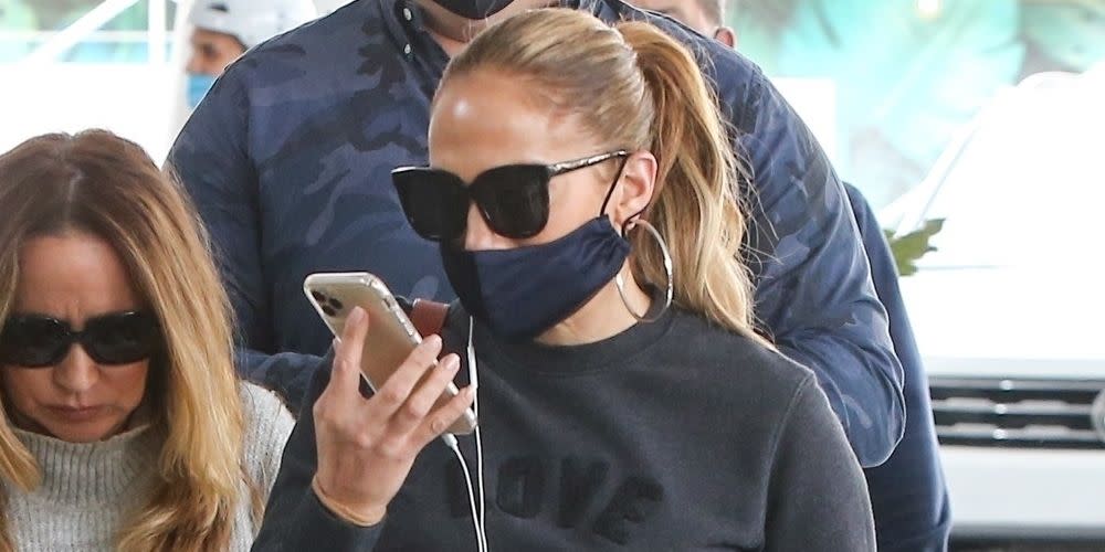 Jennifer Lopez keeps the casual style in baggy jeans, white sneakers and a love sweatshirt