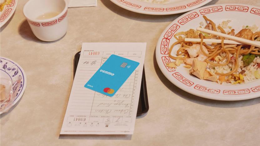 Product shot of Venmo debit card on a restaurant table with check.