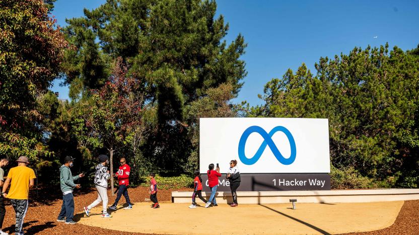 People visit a newly unveiled logo for "Meta", the new name for Facebook's parent company, outside Facebook headquarters in Menlo Park on October 28, 2021. - Facebook changed its parent company name to "Meta" on October 28 as the tech giant tries to move past being a scandal-plagued social network to its virtual reality vision for the future. (Photo by NOAH BERGER / AFP) (Photo by NOAH BERGER/AFP via Getty Images)