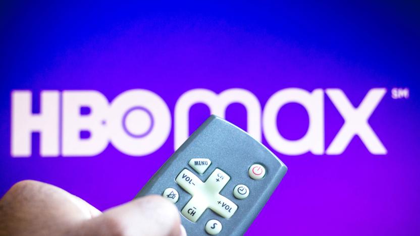 BRAZIL - 2021/06/03: In this photo illustration a close-up of a hand holding a TV remote control seen displayed in front of the HBO Max logo. (Photo Illustration by Rafael Henrique/SOPA Images/LightRocket via Getty Images)