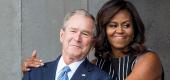 Former President George W. Bush receives a hug from First Lady Michelle Obama, September 24, 2016 in Washington, D.C. (ZACH GIBSON/AFP via Getty Images)