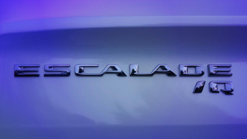 A close-up of the Cadillac ESCALADE IQ name badge seen on the vehicle. Preproduction model shown. Actual production model may vary.