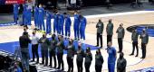 Dallas Mavericks players and staff stand during the playing of the national anthem. (AP Photo/Tony Gutierrez)