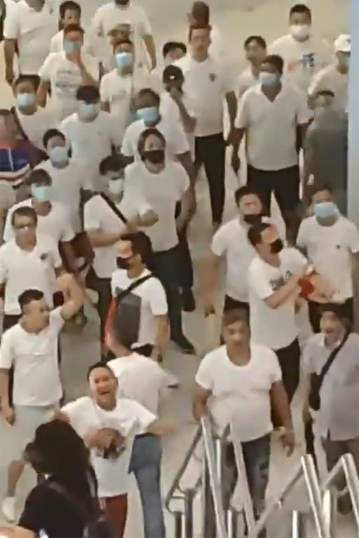 Suspected triad members dressed in white T shirts beat protesters in Hong Kong after another huge anti-government rally (AFP Photo/Handout)