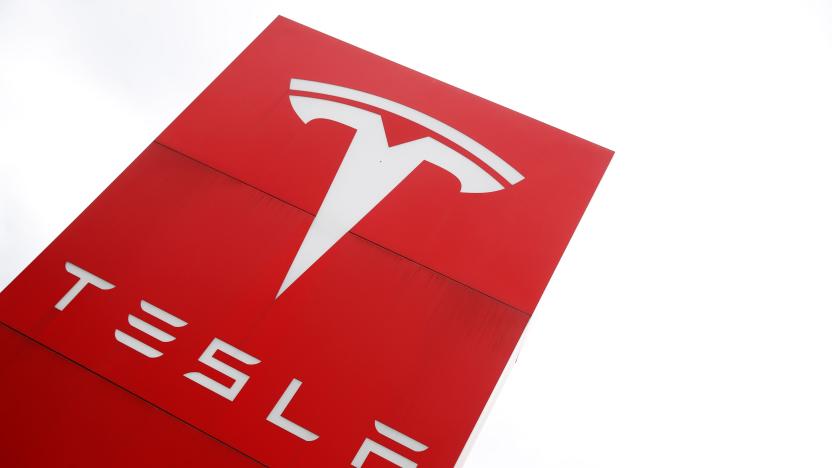 The logo of car manufacturer Tesla is seen at a dealership in London, Britain, May 14, 2021. REUTERS/Matthew Childs