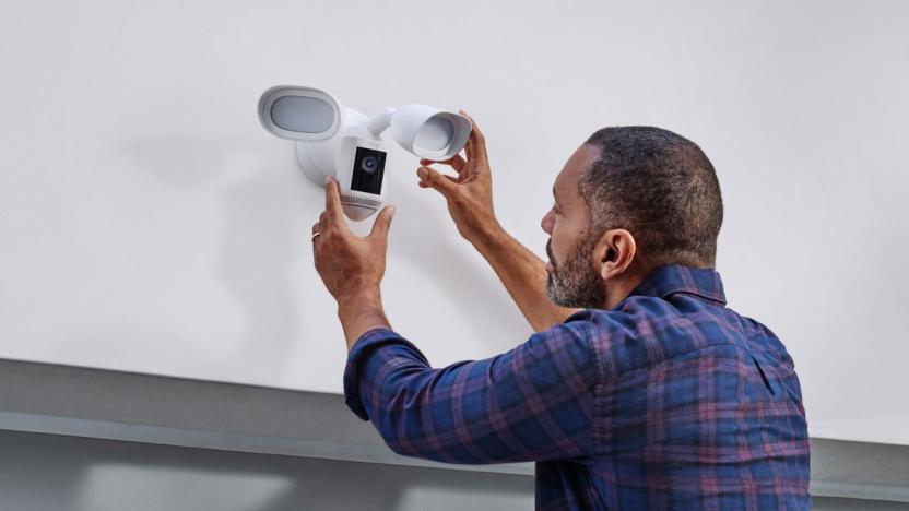 Image of a man installing a new Ring Floodlight Cam Wired Pro.