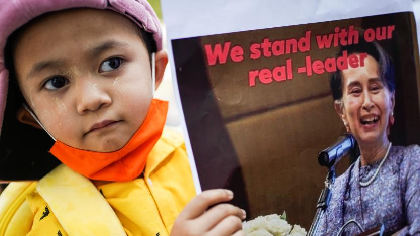 A child holds a picture of leader Aung San Suu Kyi outside the United Nations venue after the military seized power in a coup in Myanmar, in Bangkok, Thailand February 3, 2021. REUTERS/Athit Perawongmetha