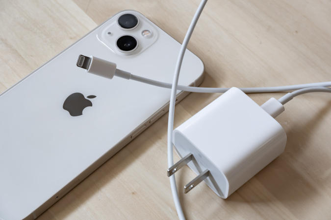 Bangkok, Thailand - January 17, 2022: An iPhone 13 with 20W power adapter and Lightning cable.