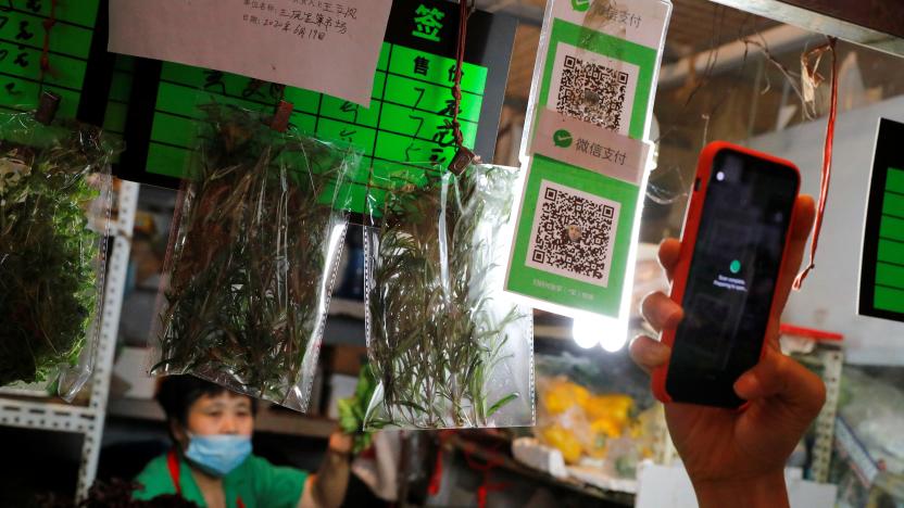 A person scans the QR code of the digital payment services WeChat Pay at a fresh market in Beijing, China August 8, 2020. REUTERS/Thomas Peter