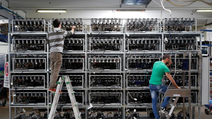 Employees work on bitcoin mining computers at Bitminer Factory in Florence, Italy, April 6, 2018. Picture taken April 6, 2018. REUTERS/Alessandro Bianchi