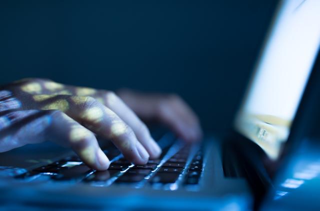 Close-up image of software engineer typing on laptop