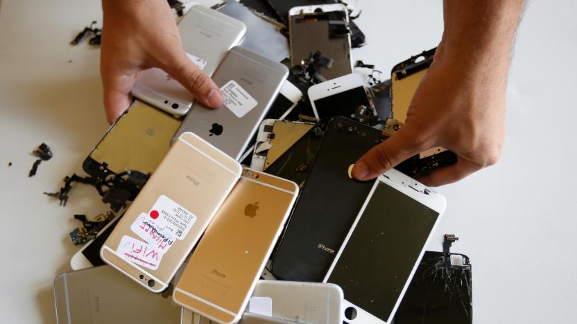 Worker checks Apple Iphones as he refurbishes cell phones at a workshop of the Oxflo company, specialised in refurbishment of broken European smartphones which will be resold back and provided with a warranty as part of an eco-responsible approach, in Lusignac, France, June 20, 2019. REUTERS/ Regis Duvignau