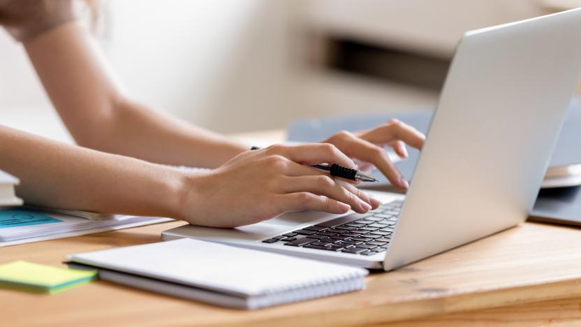 Closeup cropped image student girl hands typing using laptop