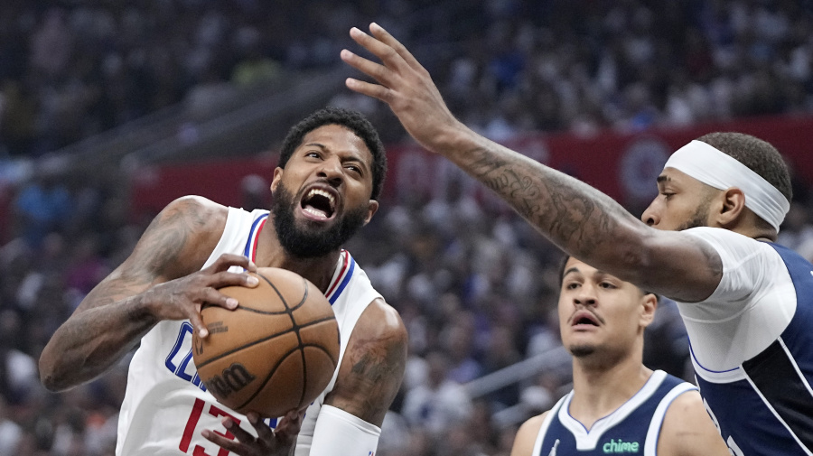 Associated Press - Los Angeles Clippers forward Paul George, left, tries to shoots as Dallas Mavericks guard Josh Green, center, and center Daniel Gafford defend during the first half in Game 5 of an NBA basketball first-round playoff series Wednesday, May 1, 2024, in Los Angeles. (AP Photo/Mark J. Terrill)