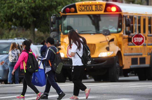 A family walks to school together on the first day of New York City Public Schools in the Brooklyn borough of New York, U.S., September 8, 2022.  REUTERS/Brendan McDermid