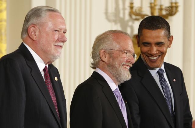 U.S. President Barack Obama (R) smiles next to Adobe Systems representatives John Warnock (C) and Charles Geschke (L) during an awards ceremony for the National Medal of Technology and Innovation at the White House in Washington October 7, 2009.    REUTERS/Jim Young    (UNITED STATES POLITICS SCI TECH)