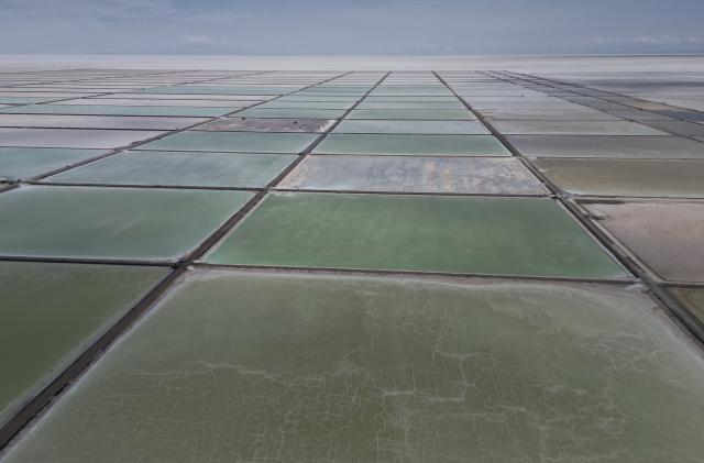 Aerial view of the salt recovery pools in different degrees of evaporation at an industrial plant that produces lithium carbonate to manufacture lithium batteries, after the plant's opening ceremony in the Uyuni salt desert on the outskirts of Llipi, Bolivia, Friday, Dec. 15, 2023. (AP Photo/Juan Karita)